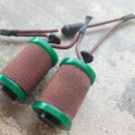 Brown sanding sleeves with green caps and wires