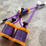 Close-up of purple tattoo machine coils