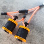 Orange wires with black foam grips