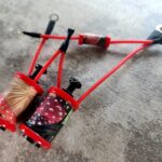 Red-wired tattoo machine with patterned grips