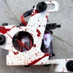 Tattoo machine with blood splatter design details.