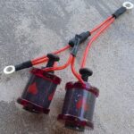 Red tattoo machine coils with heart designs.