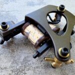 Vintage tattoo machine with decorative coils.